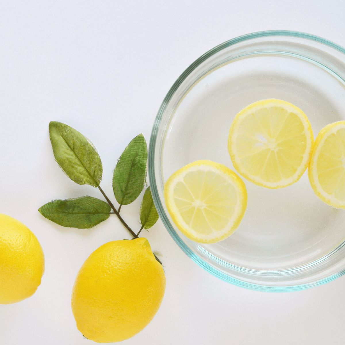 Lemons with a glass of lemon water