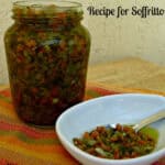 A jar of Italian soffritto with a bowl of the prepared Italian aromatics on in white bowl.