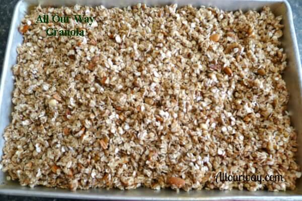 Granola mixture in a deep aluminum pan ready for the sweet mixture. 