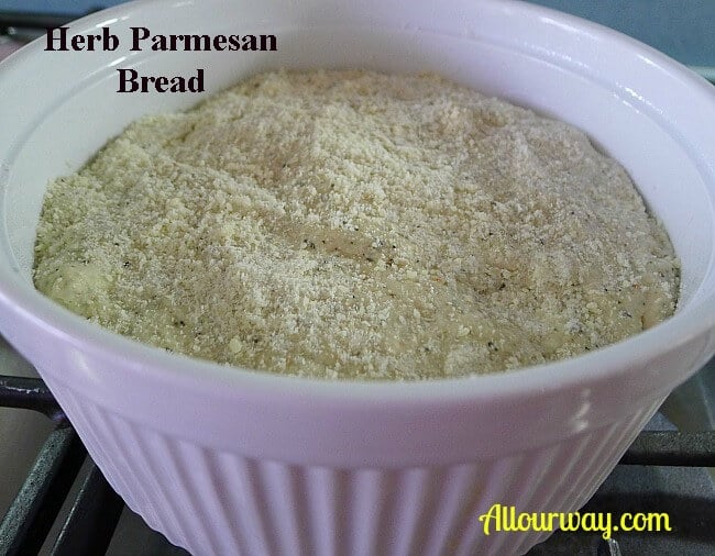 Herb Parmesan Bread dough in 2 Quart round white souffle dish with parmesan cheese sprinkled on top. 