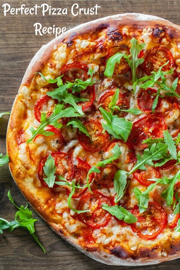 Pizza with cheese, red sauce and green arugula topping. 