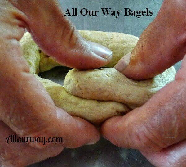 Hands pinching the ends of the dough rope into a circle, even roll