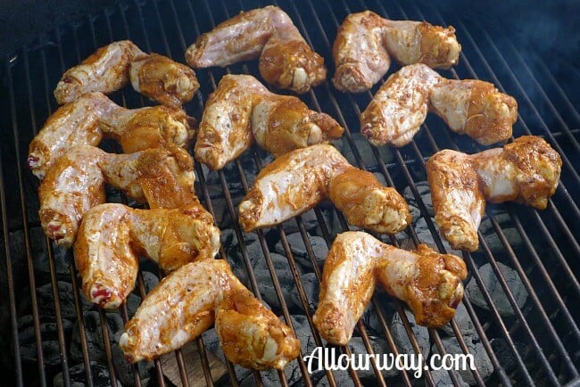 Chicken wings on the grill with the outer side down.