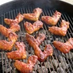 Chicken wings on the grill with All Our Way Bourbon Barbecue Sauce at allourway.com