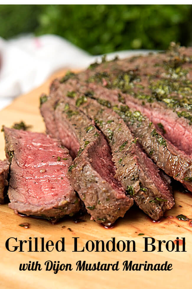 London broil steak sliced on a wooden cutting board. 