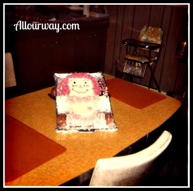 Raggedy Ann Cake for a Birthday on a yellow formica table. 