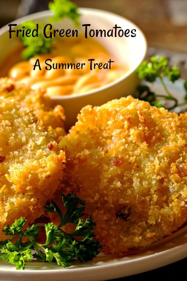 fried green tomatoes with green parsley and creamy dipping sauce in background. 