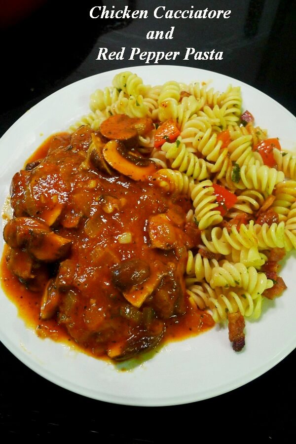 Chicken Cacciatore with red sauce and rotini pasta on a white dish