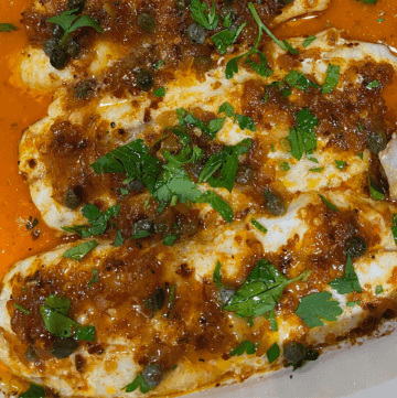 Spicy Lemon Sea Trout in White Casserole pan with paprika lemon caper sauce