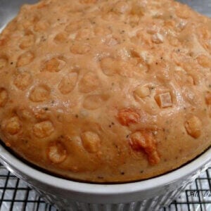 Stud Muffin in a souffle dish -- studded with Gruyère, cooling on a rack.