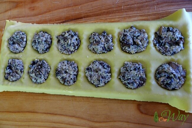 The cheese and mushroom filling is added to the ravioli pockets.