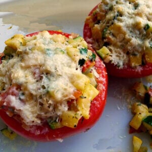 Tomatoes are stuffed with zucchini, summer squash, onion, garlic and flavored with basil, thyme and Parmesan Cheese.