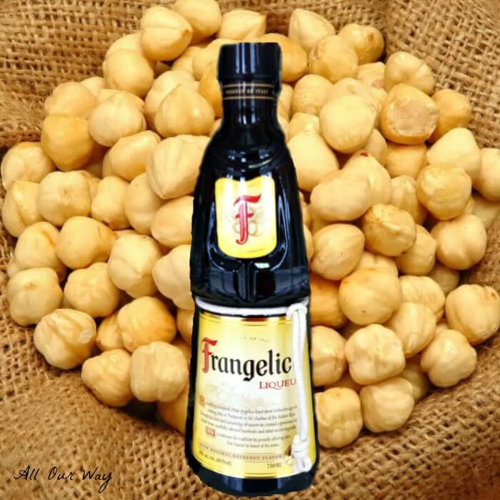 Frangelico a hazelnut and herb Liqueur with hazelnuts in background on burlap. @allourway.com