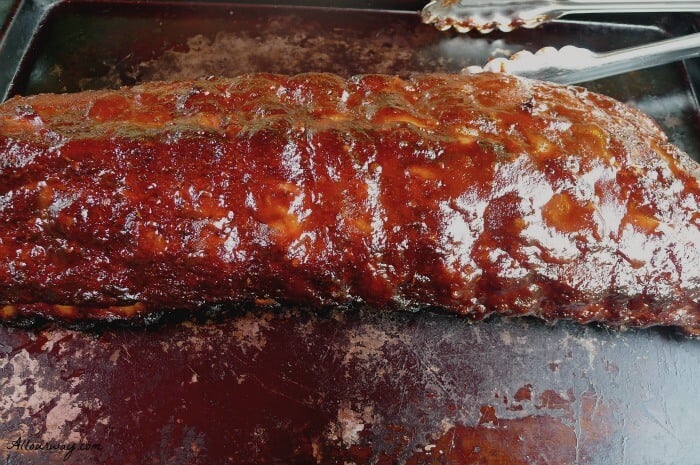 Barbecued Babyback ribs resting before slicing and serving with Skillet Fried Italian Herbed Potatoes @allourway.com