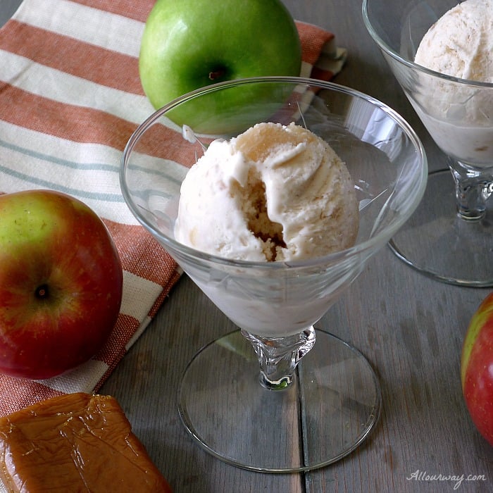 Caramel Apple Pie No-Churn Ice Cream in a glass goblet surrounded by apples and caramels. 