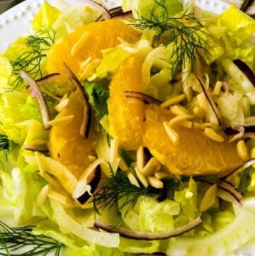 Fennel Orange Salad with Romaine and Almonds on white plate.