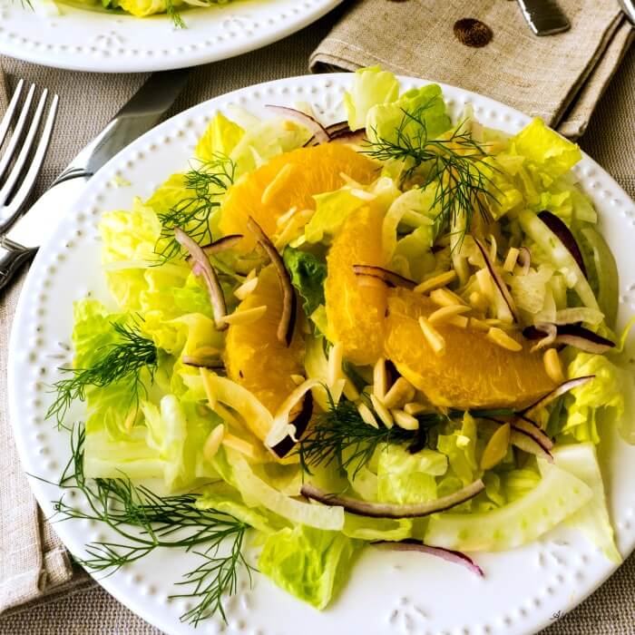 Fennel Orange Salad is a light salad with shaved fennel, sweet orange segments, slivered purple onion, and crunchy romaine and. A light citrus vinaigrette dresses the salad. @allourway.com