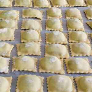 Row after row of Spinach Ricotta Beef Ravioli Filling lined up on cookie sheet ready to freeze.
