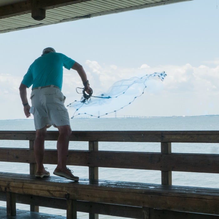 On Saint Simons Island Pier casting a net for bait @allourway.com