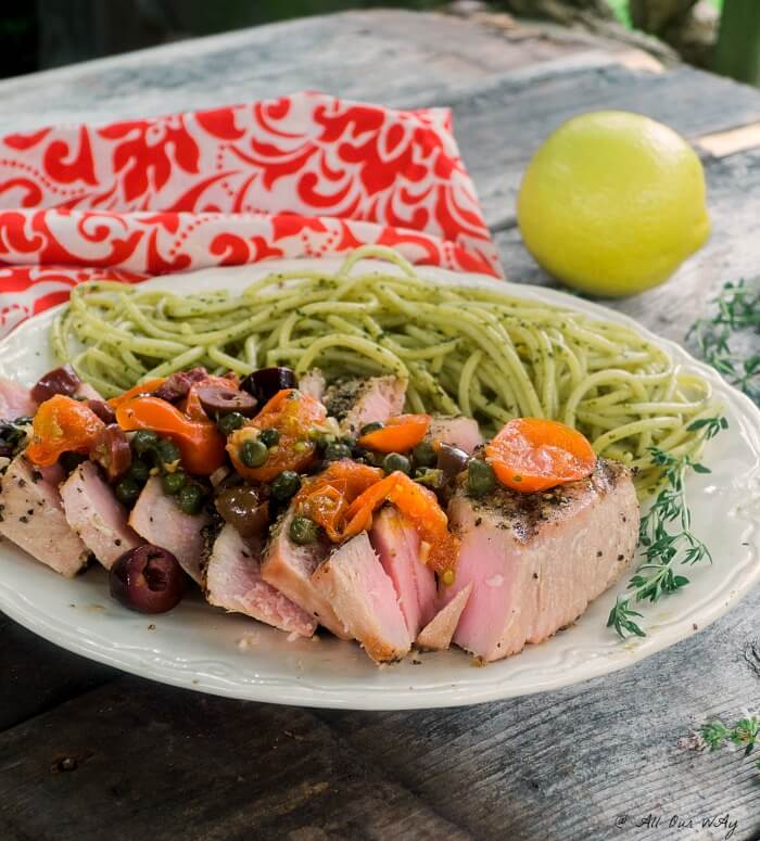 Southern Italian Grilled Tuna Steaks topped with a fresh sauce made up of grape tomatoes, capers, olives, wine and lemon @allourway.com