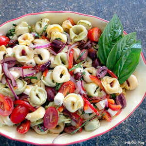 A bowl filled with colored tortellini pasta salad.