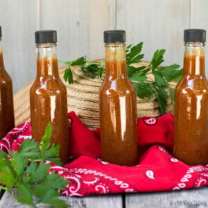 Homemade peach Habañero hot sauce in small serving bottles.