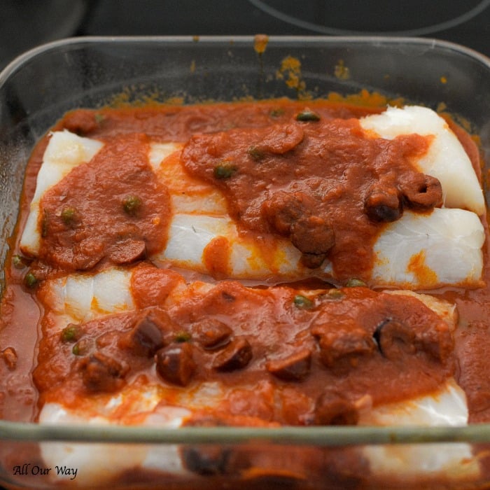 Baked Cod Puttanesca is a quick and easy dish that bakes cod fillets with a spicy tomato sauce that's boosted with kalamata olives, capers, and red pepper flakes. 