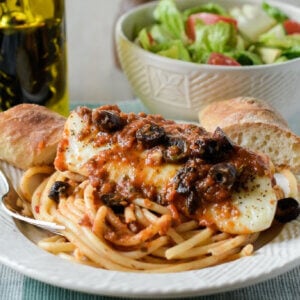 Baked Cod puttanesca over spaghetti with Italian bread.