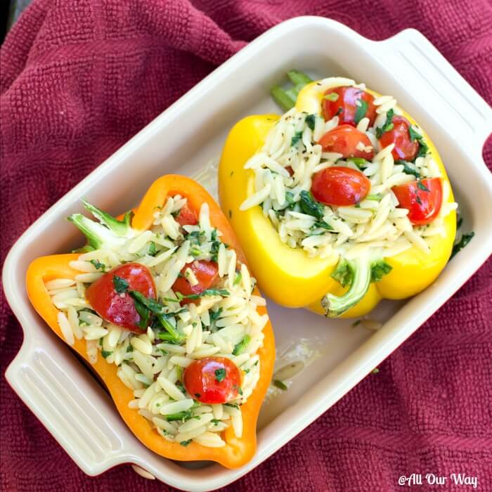 Orzo stuffed peppers Italian style with spinach and grape tomatoes.