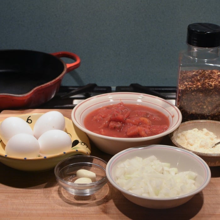 Spicy Eggs in Purgatory poaches eggs in a spicy tomato sauce. Quick and easy.