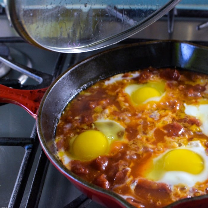 Spicy Eggs in Purgatory poaches eggs in a spicy tomato sauce. Quick and easy.