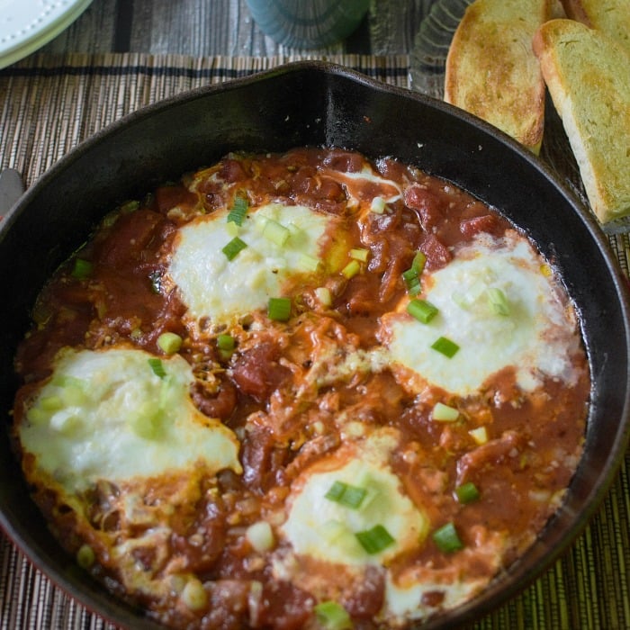 Spicy Eggs in Purgatory poaches eggs in a spicy tomato sauce. Quick and easy. 