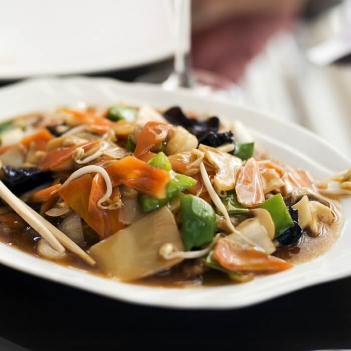 Chicken Chop Suey in a white bowl. The recipe is very adaptable to any meat and vegetable using carrots, green peppers, bean sprouts. 