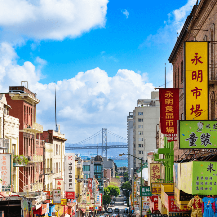 Photo of Chinatown in San Francisco with the San Francisco bridge in the background. Chop Suey originated in San Francisco in the late 1900s.