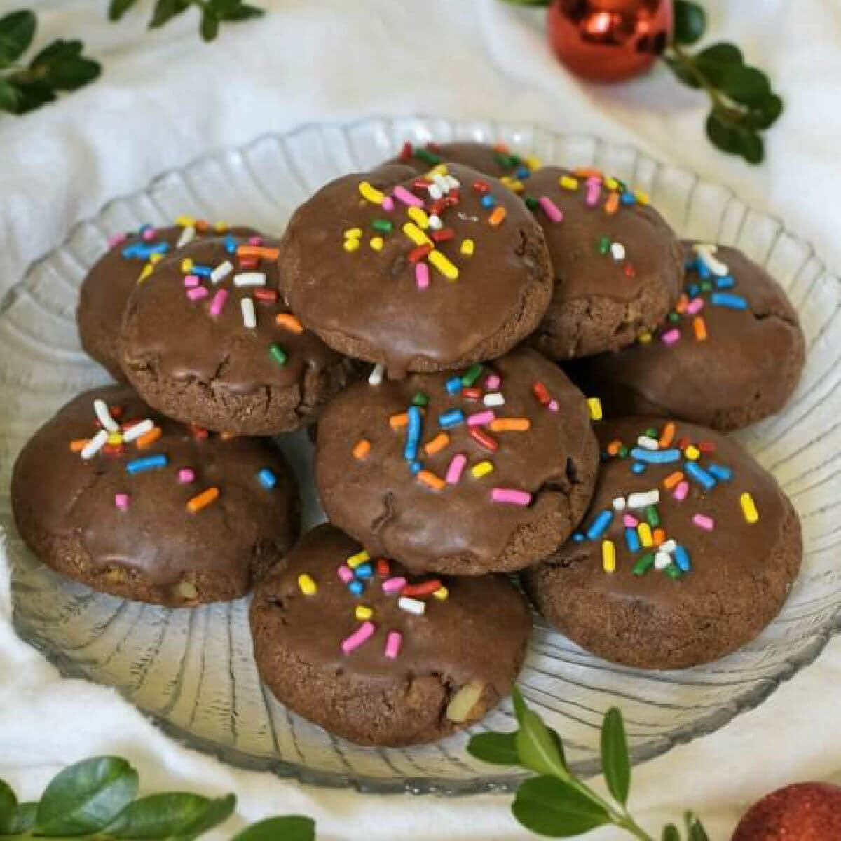 Italian Chocolate Toto Cookies are Christmas spice cookie that's studded with walnuts, chocolate chips, spices, and flavored with orange. Glazed with chocolate and topped with colorful sprinkles.