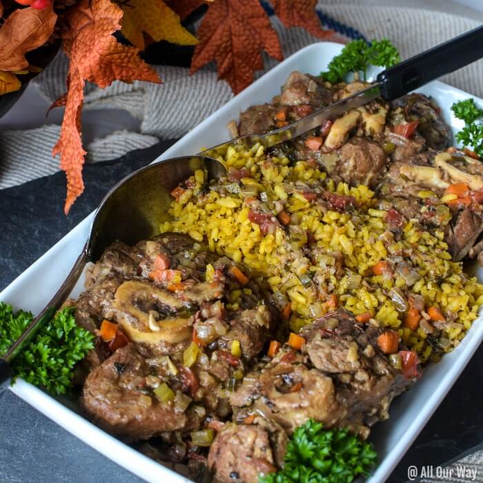 Ossobuco alla Milanese on white rectangular Platter with yellow Saffron Risotto