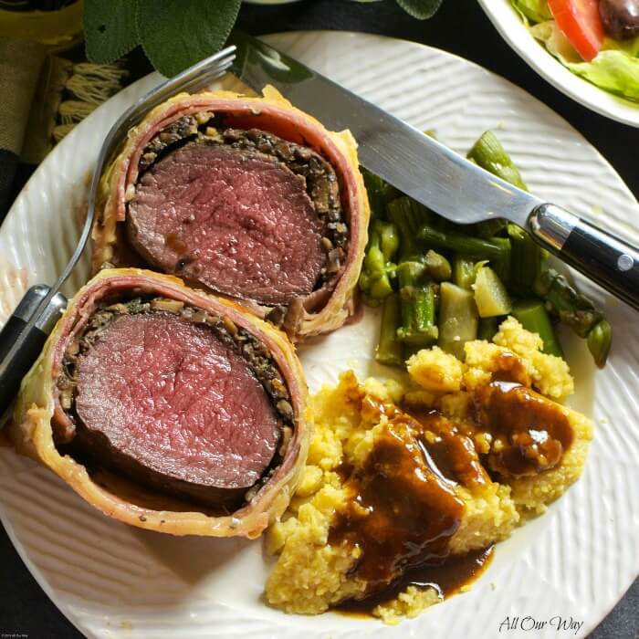 Italian Venison Wellington on plate with polenta and Marsala sauce.#venison_tenderloin, #marsala_sauce, #deer_meat, #puff_pastry, #venison_fillet, #roast_venison, #allourway