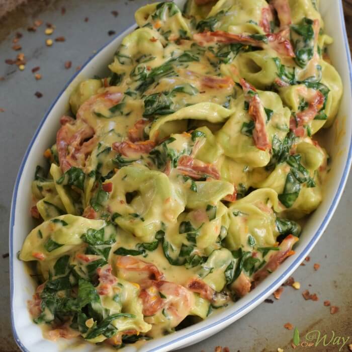 A serving of Creamed Tuscan style tortellini in bowl. 