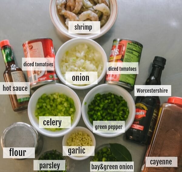 The ingredients for Shrimp Creole are all prepared and on a stainless steel table. 