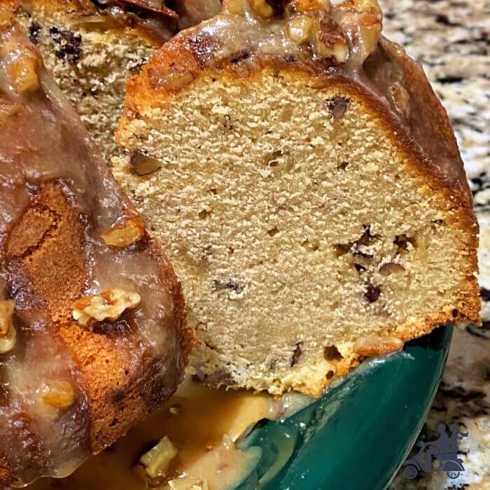 Slice of Pecan praline cake studded with pecans and bits of toffee. 