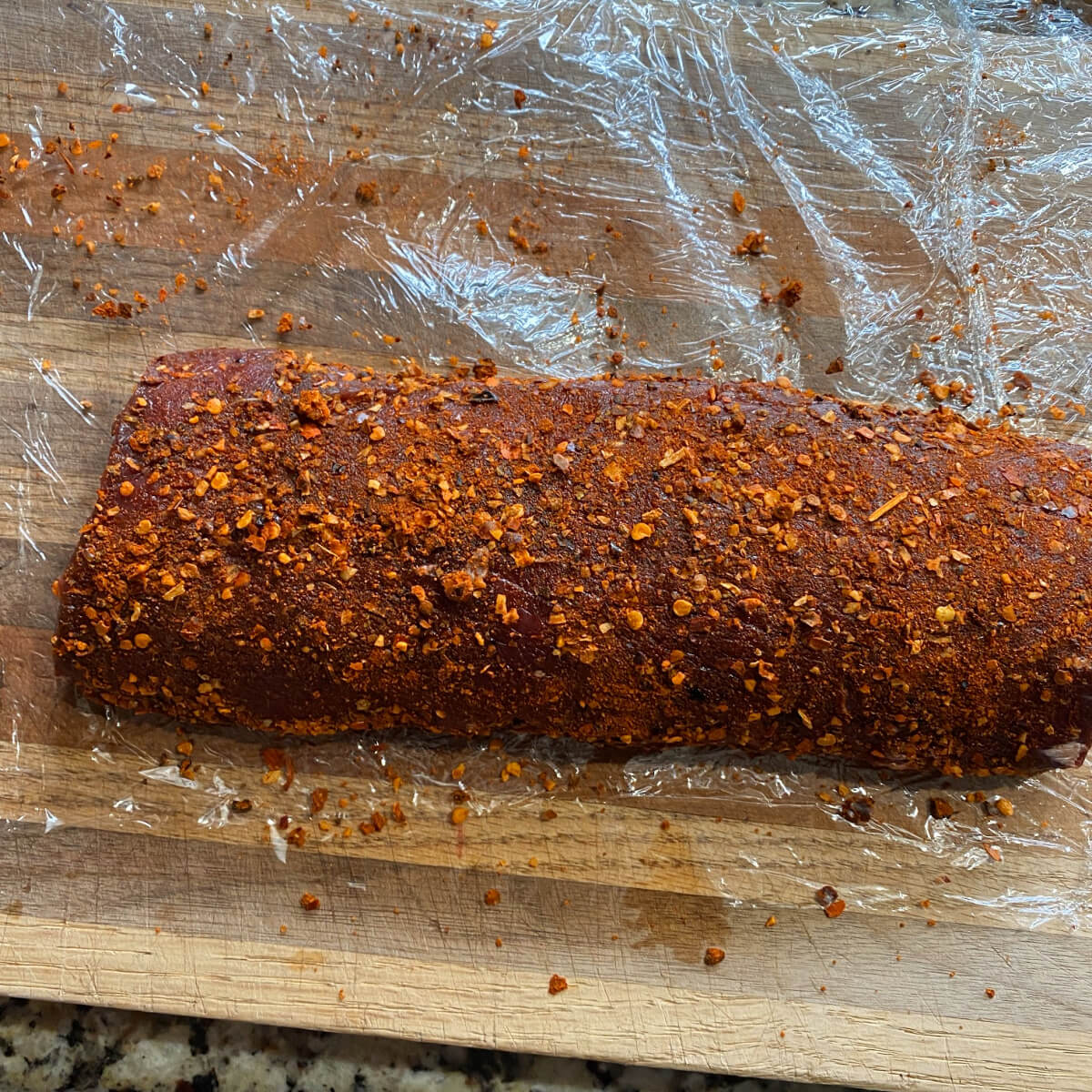 Venison Backstrap with dry rub on cutting board. 