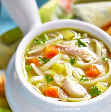 Chicken Noodle Soup with Carrots and Celery in White Bowl.