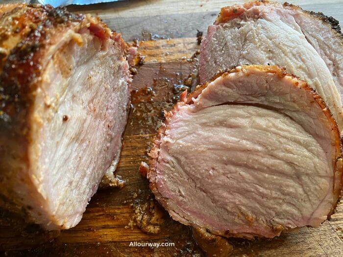 Showing slices from grilled sirloin tip pork roast that is juicy and done. 