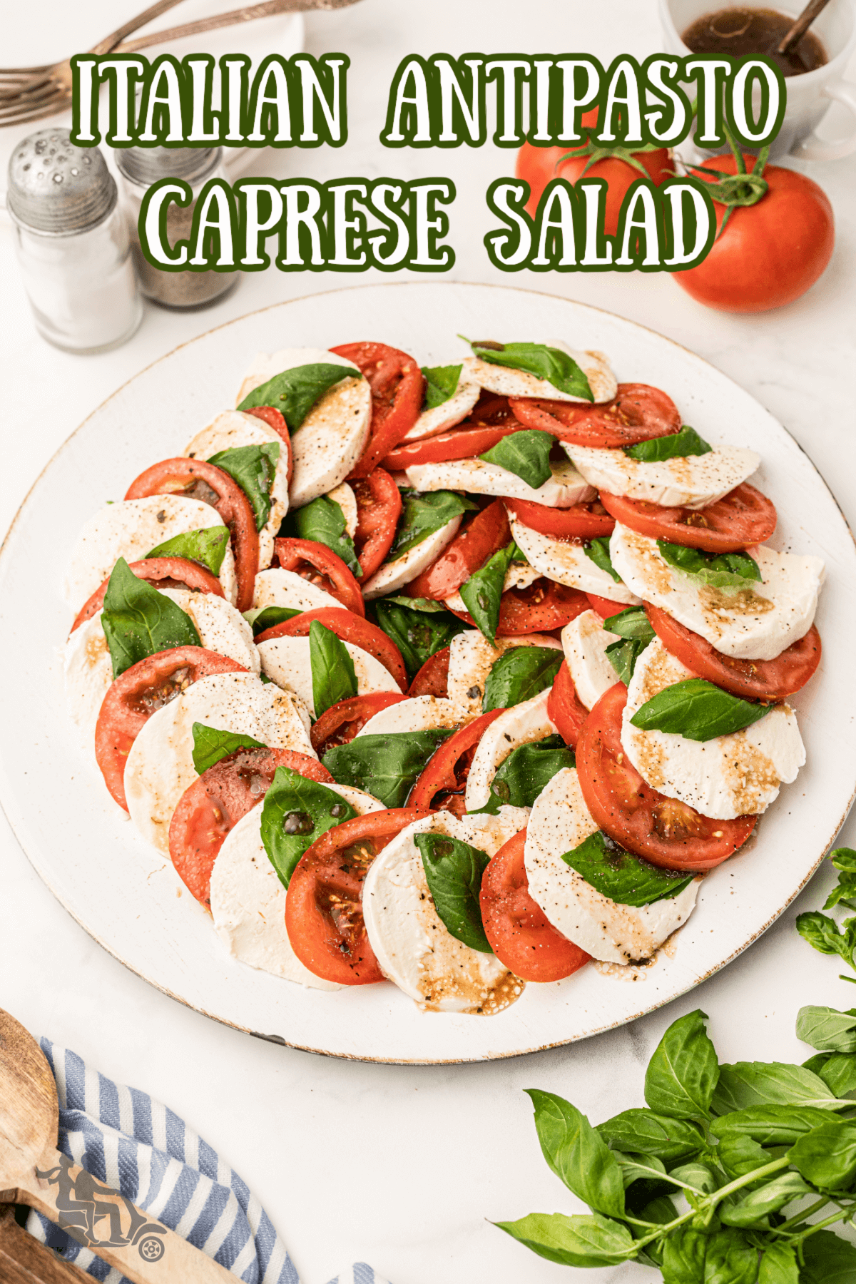 A platter of Caprese Salad with the tomatoes, mozzarella, and basil layered to reflect the colors of the Italian flag. 