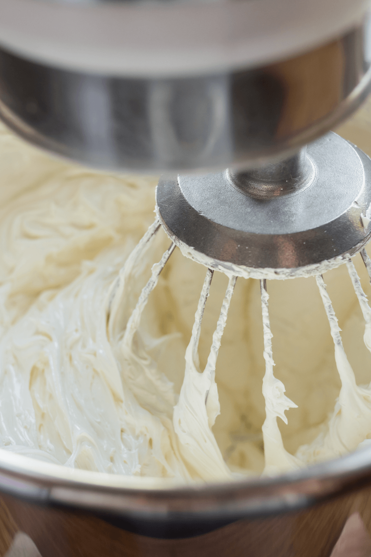 Electric stand mixer mixing whipping cream. 