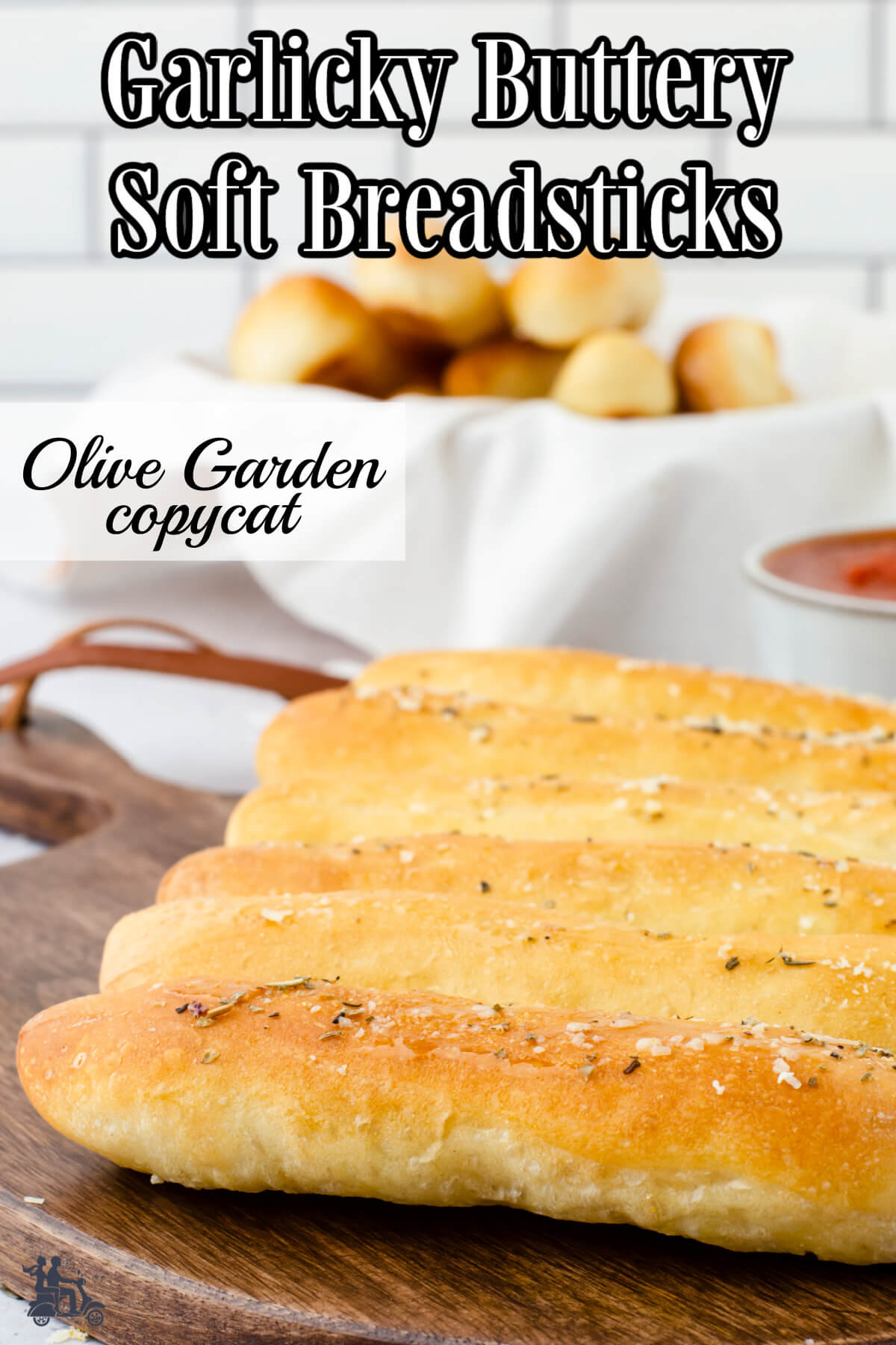 Soft breadsticks on cutting board and breadbasket. 