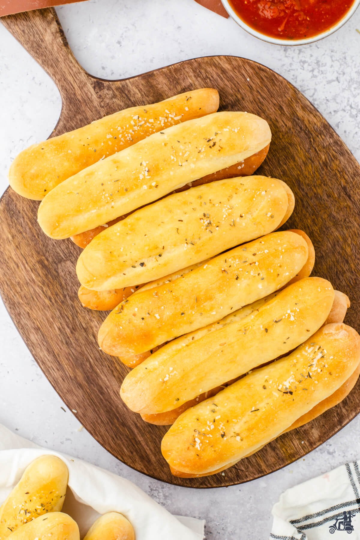 Soft breadsticks on cutting board. 