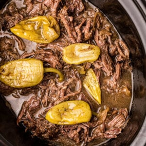 Italian pot roast in a slow cooker with peperoncini.