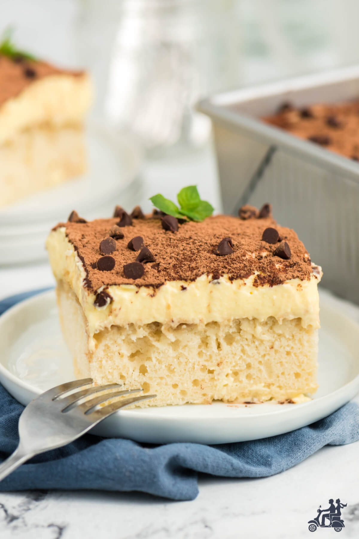 Serving of Tiramisu Cake on plate with fork. 