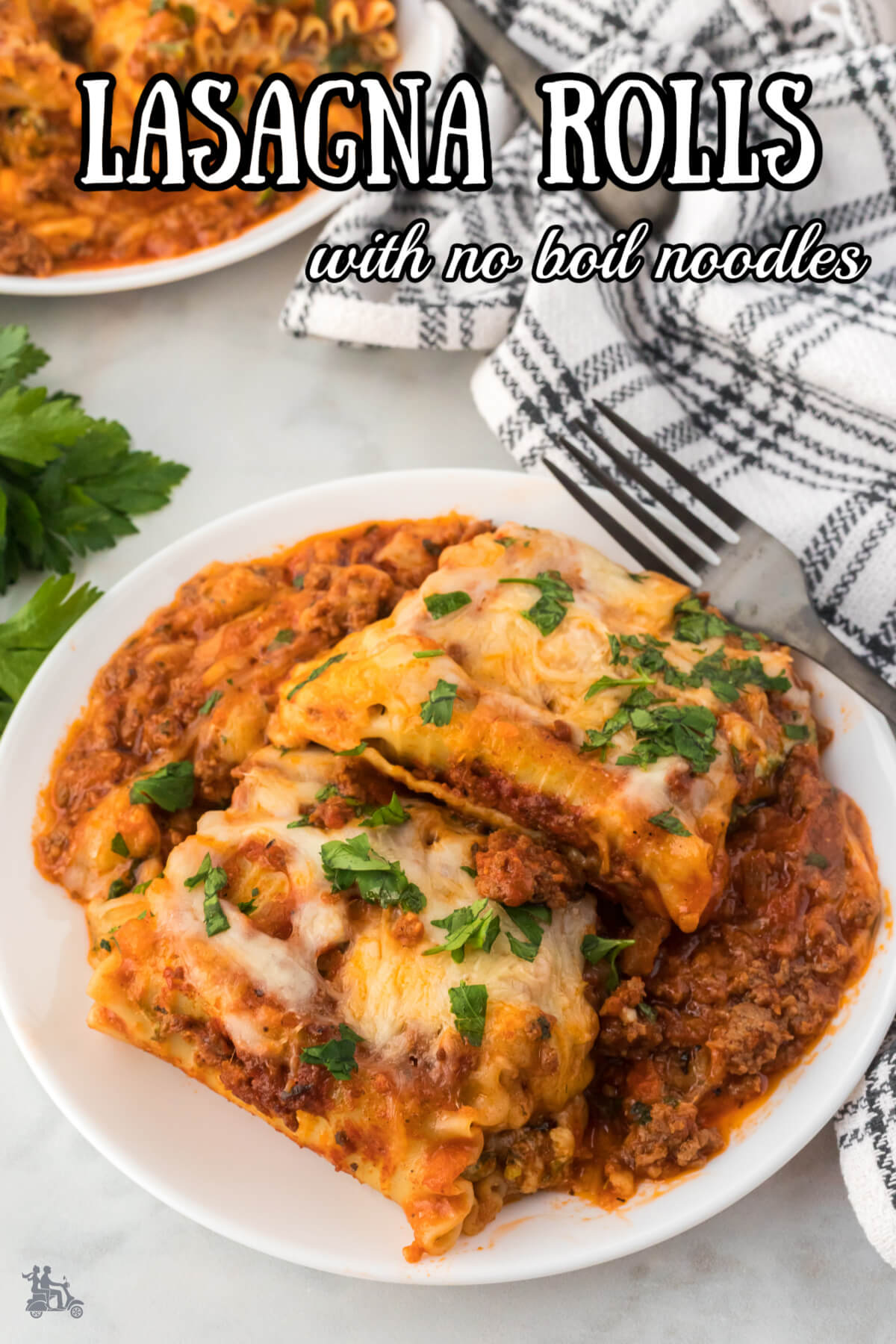 Lasagna roll up with meat sauce on a white plate. 